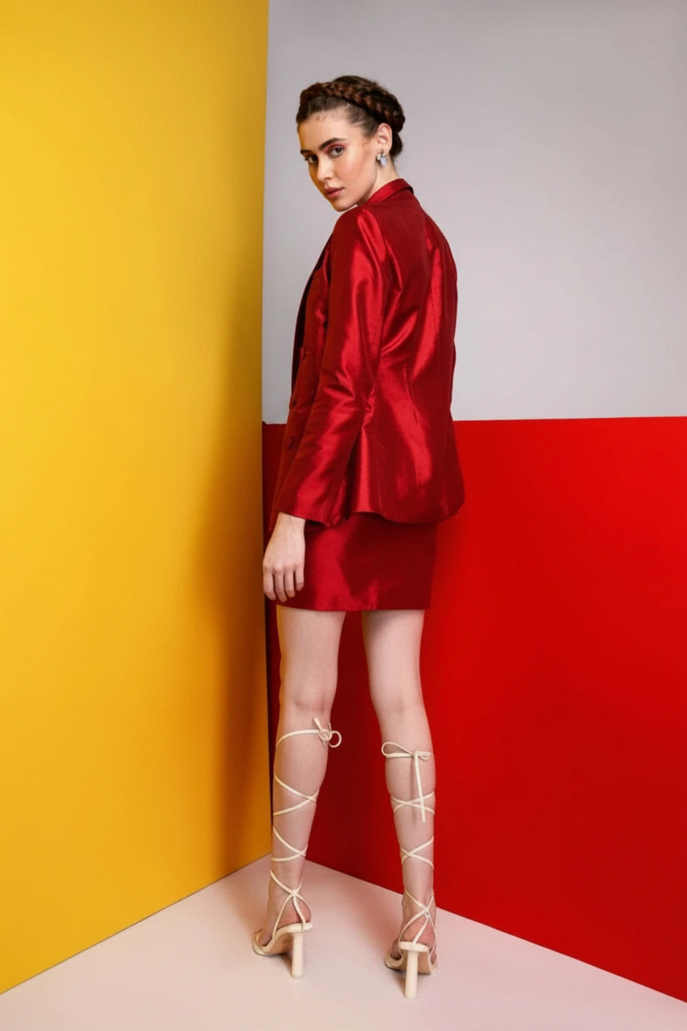 Woman wearing a black and white dress against a gray background