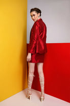 Woman wearing a black and white dress against a gray background