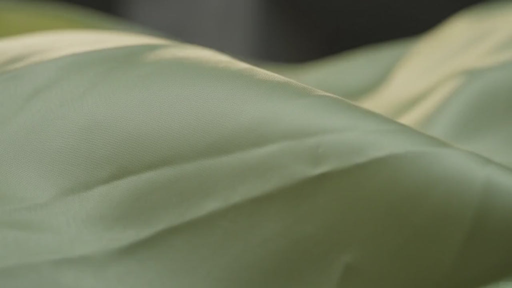 Woman wearing a green satin outfit against a dark background. Pale Lime Ruched Satin Coord Set
